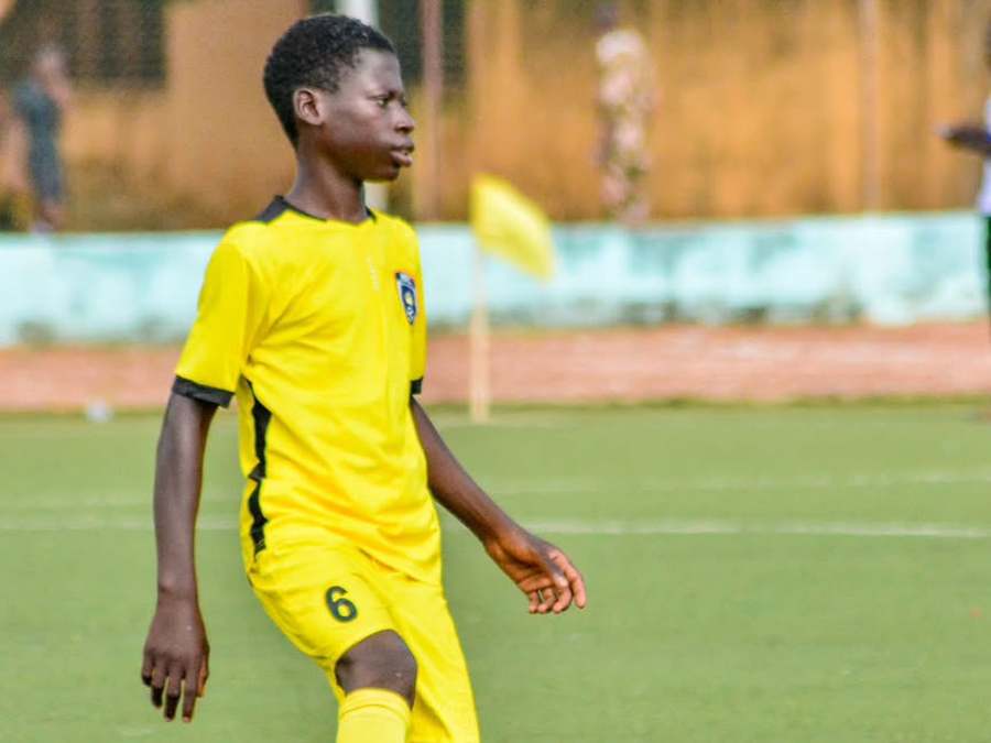 Un joueur de Hooli Académie, maillot jaune numéro 6, conduit le ballon.